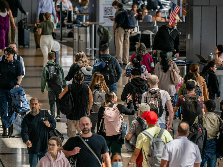 People travel through the Austin-Bergstrom International Airport on Thursday.