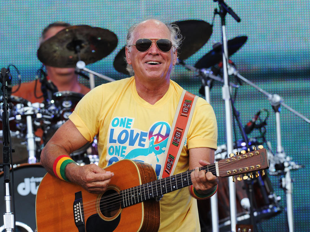 Musician Jimmy Buffett performs onstage at Jimmy Buffett & Friends: Live from the Gulf Coast, a concert presented by CMT at on the beach on July 11, 2010 in Gulf Shores, Alabama.