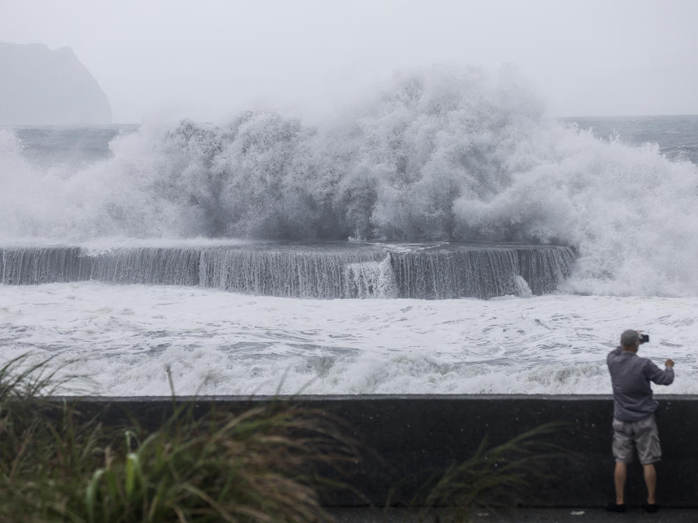 A man takes pictures of huge waves in Yilan as Typhoon Haikui makes landfall in eastern Taiwan on Sunday, Sept. 3, 2023.