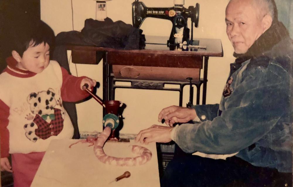 Yeye teaching me (age 3) how to grind sausages in our old Wuhan apartment in 1999.