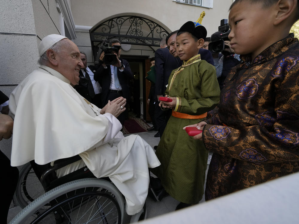 Children in traditional dress welcome Pope Francis arriving for a meeting with charity workers and for the inauguration of the House of Mercy in Ulaanbaatar, Monday, Sept. 4, 2023.