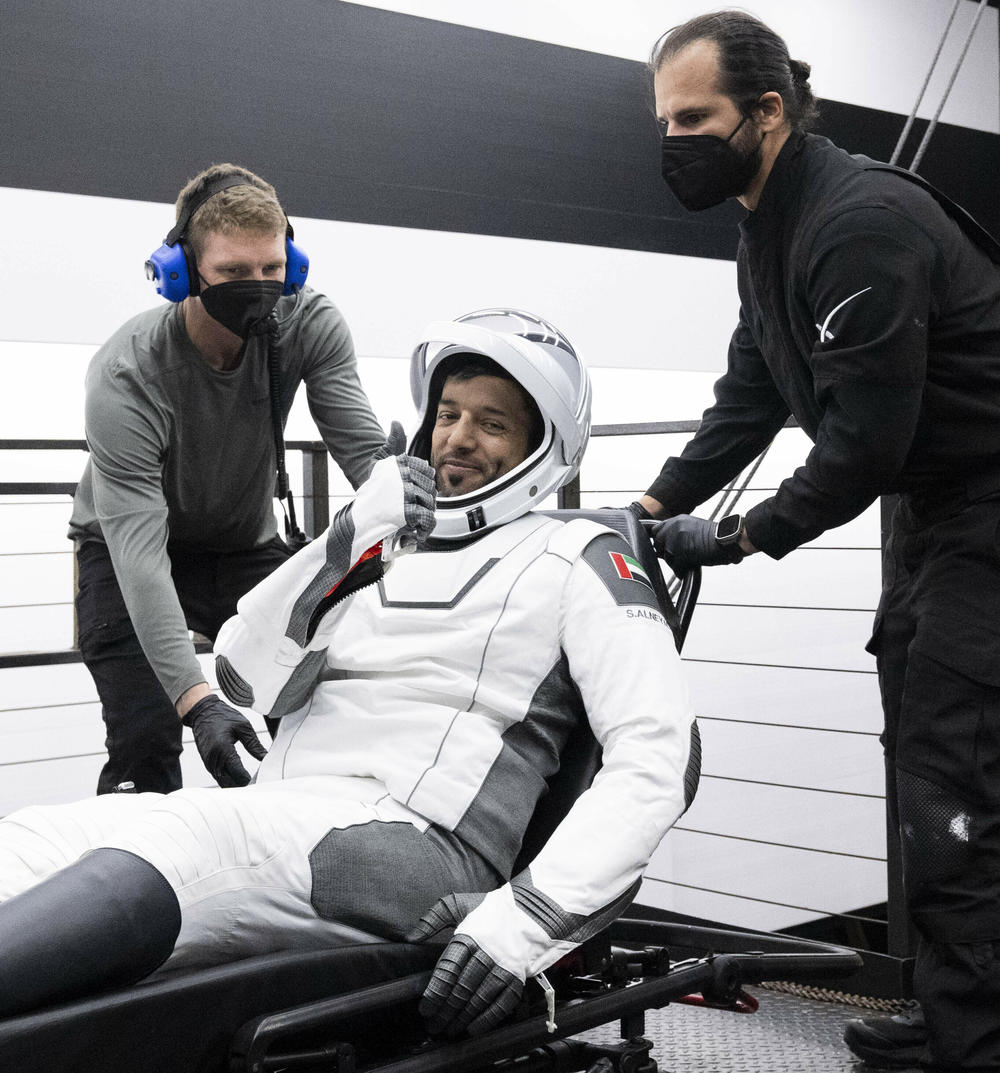 In this photo provided by NASA, United Arab Emirates astronaut Sultan Alneyadi gestures as he is helped out of a SpaceX capsule onboard a recovery ship after he and NASA astronauts Warren 