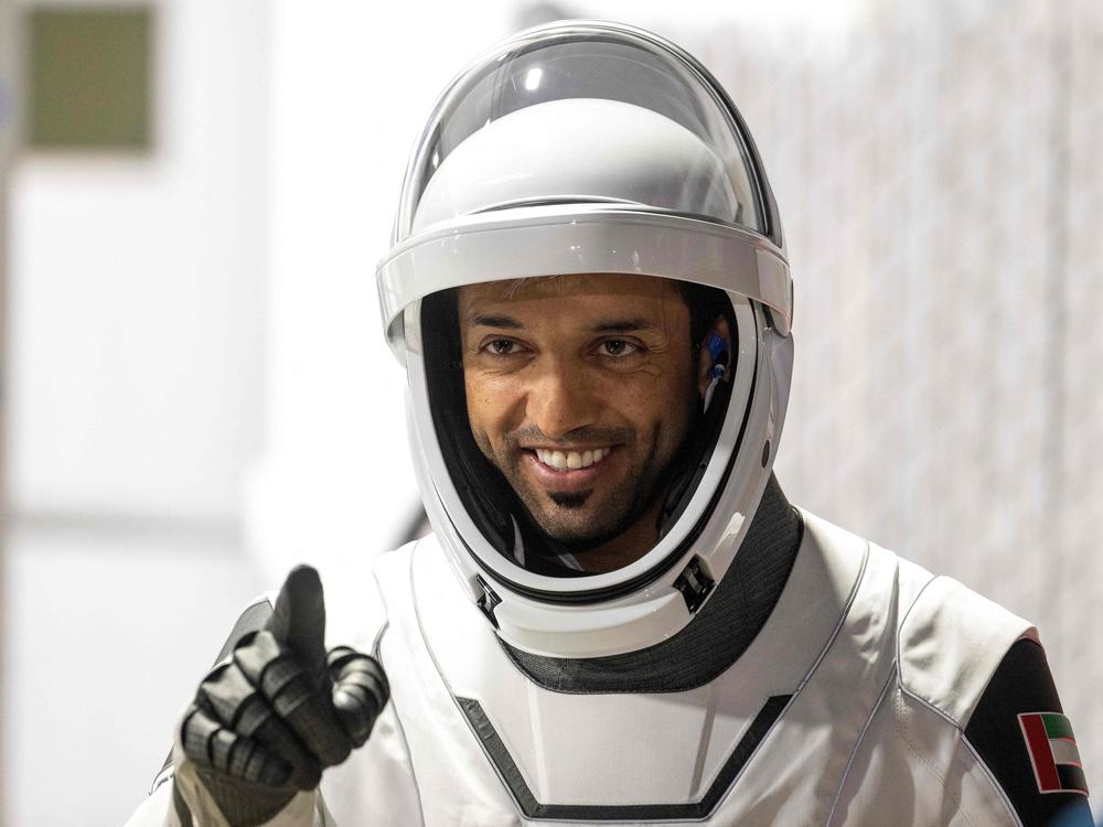 Mission Specialist Sultan Alneyadi of the United Arab Emirates, member of the SpaceX Dragon Crew-6 mission, gestures during the crew walkout from the Neil A. Armstrong Operations and Checkout Building for Launch Complex 39A ahead of their liftoff at NASA's Kennedy Space Center in Cape Canaveral, Fla., on March 1.