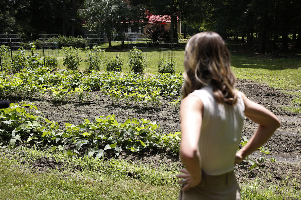 Clayton looks over her father's garden where he's grows a range of vegetables including corn, cucumbers, squash, tomatoes and peppers in Roxboro, N.C.