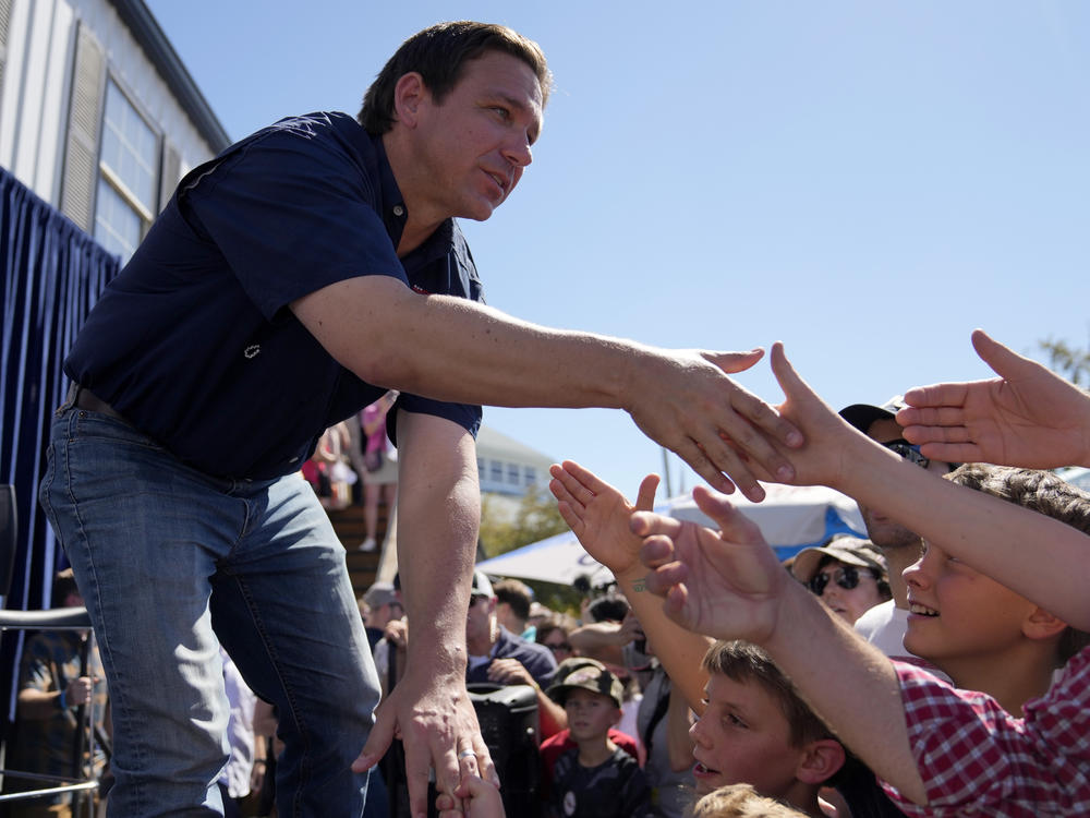 Republican presidential candidate and Florida Gov. Ron DeSantis shakes hands with fairgoers at the Iowa State Fair on Aug. 12 in Des Moines, Iowa.