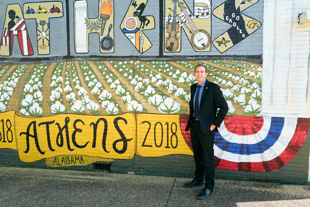 Wahl stands in front of a mural located in Athens, Ala., where he was born and raised. As chair, he's hoping to raise Alabama's profile, inviting major party personalities like former President Donald Trump and Florida Gov. Ron DeSantis, both Republican presidential hopefuls, to speak at record-breaking fundraisers.