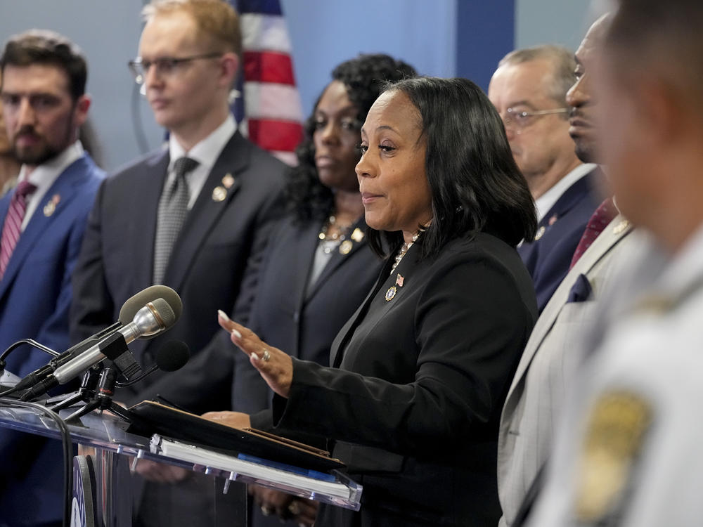 Fulton County District Attorney Fani Willis, center, during a news conference on Aug. 14.