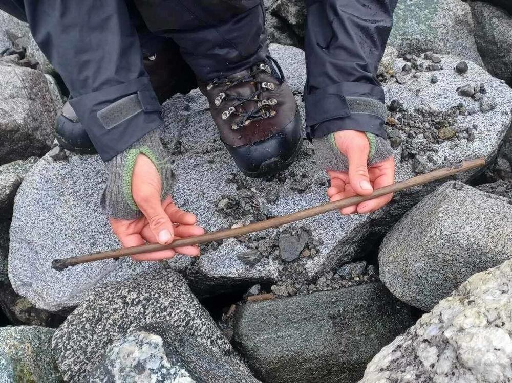 An archaeologist holds an arrow originally believed to be from the Iron Age on Mount Lauvhøe in Norway. Upon closer inspection, the team determined the artifact is from the Stone Age and is likely around 4,000 years old.