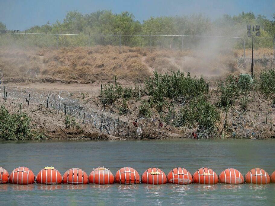 A barrier to deter migrants from crossing from Mexico into the U.S. floats in the Rio Grande at Eagle Pass, Texas.