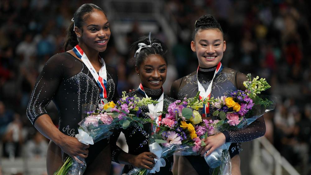 Gymnasts Shilese Jones, Simone Biles and Leanne Wong pose after placing second, first and third in the all-around competition on the final day of women's competition at the 2023 U.S. Gymnastics Championships on Sunday in San Jose, Calif.
