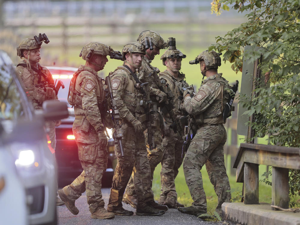 Pennsylvania State police search the woods and a creek in Pennsbury Township, Pa., on Tuesday, Sept. 5, 2023. Murderer Danelo Cavalcante was able to escape a prison yard in suburban Pennsylvania last week by climbing up a wall and over razor wire, officials said at a news conference Wednesday.