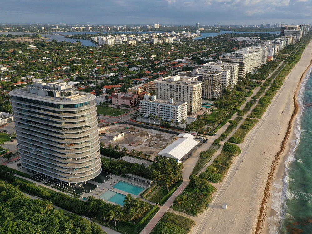 In an aerial view, a cleared lot where the 12-story Champlain Towers South condo building once stood is seen on June 22, 2022 in Surfside, Fla. Ninety-eight people died when the building partially collapsed on June 24, 2021.