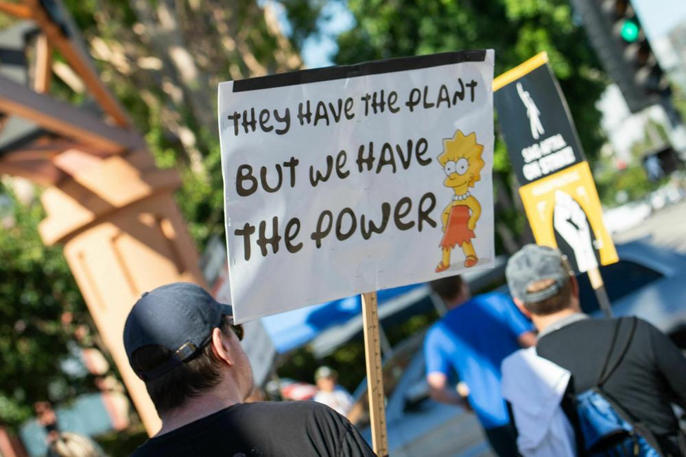 Members of the Writers Guild of America and SAG-AFTRA walk the picket line outside of Disney Studio, in Burbank, California, on Aug. 16.