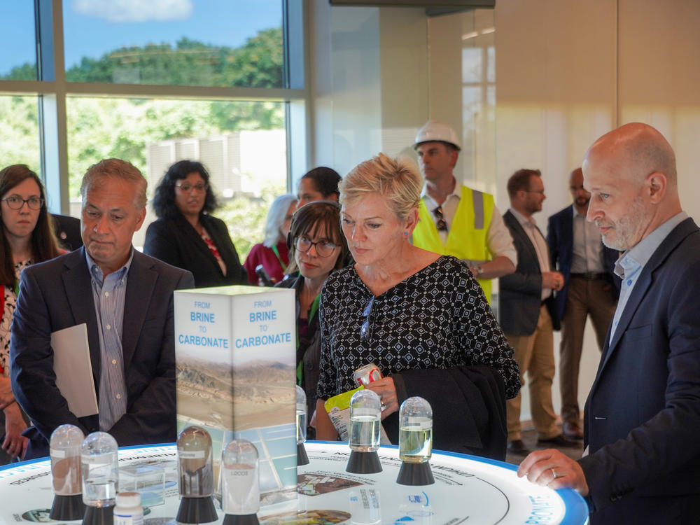 Granholm talks to executives from Albemarle, a maker of lithium, a vital component of electric vehicle batteries, in Kings Mountain, N.C. Pictured behind her is NPR reporter Camila Domonoske.