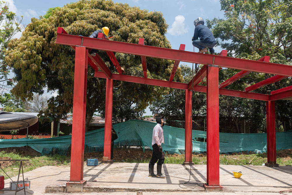 A construction worker at the town's soccer stadium. Despite running the town from afar, Molina has managed to push forward renovation of the stadium.