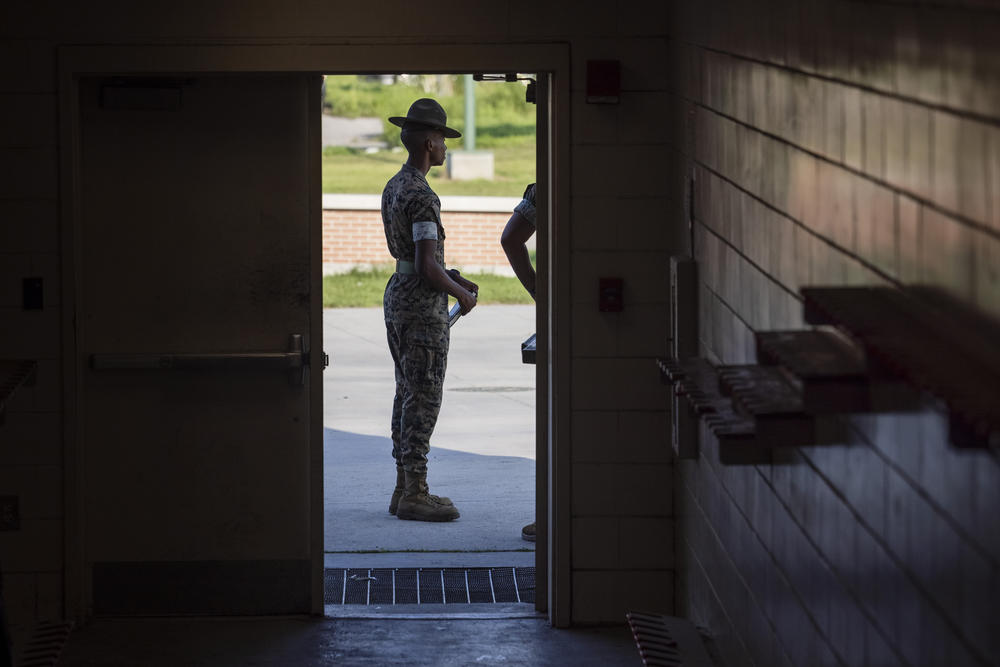 Marine Corps drill instructors wait outside an auditorium as Fox Company 2nd Recruit Training Battalion participate in a history class at Marine Corps Recruit Depot, Parris Island on August 22 in Beaufort County, S.C