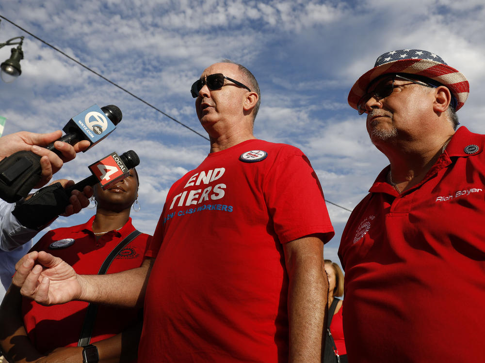 United Auto Workers President Shawn Fain talks with the news media before marching in the Detroit Labor Day Parade on September 4, 2023 in Detroit, Michigan.