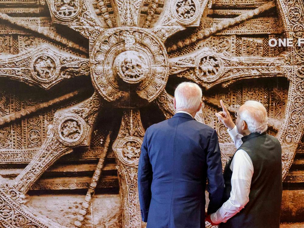 India's Prime Minister Narendra Modi shows a mural of the Konark Sun temple wheel to President Biden at the G20 summit in New Delhi.