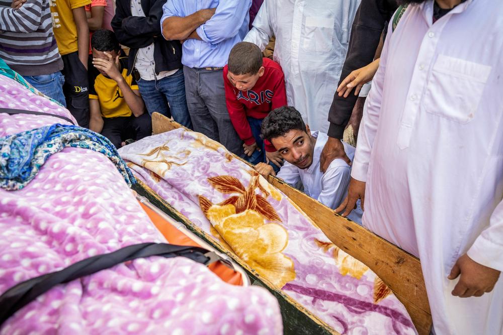 Relatives mourn in front of the bodies of the victims killed in an earthquake in Moulay Brahim, Al Haouz province.