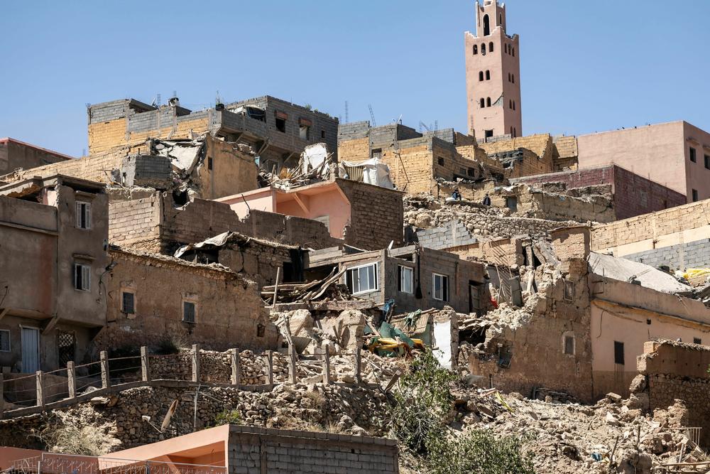 The minaret of a mosque stands behind damaged or destroyed houses following an earthquake in Moulay Brahim, Al-Haouz province.