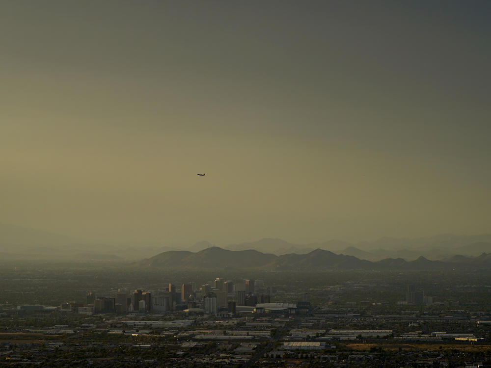 Clouds surround downtown Phoenix at sunset on July 30, 2023.