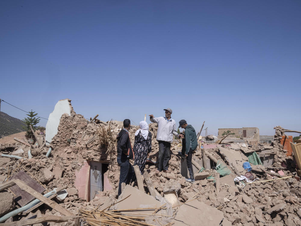 People inspect the damage caused by the earthquake in the Tafeghaghte, where displaced people worried about where to find shelter.