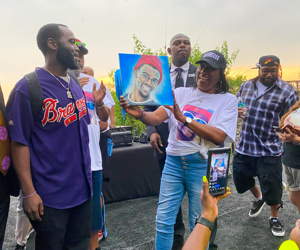 RowVaughn Wells holds up a portrait of her son, Tyre Nichols, at a celebration for what would have been his 30th birthday on June 5, 2023.