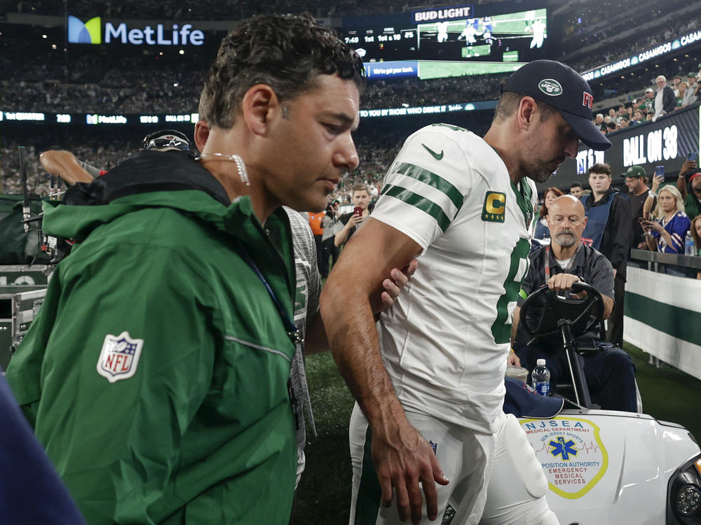 New York Jets quarterback Aaron Rodgers is helped off the field during the first quarter of an NFL football game against the Buffalo Bills on Monday in East Rutherford, N.J.