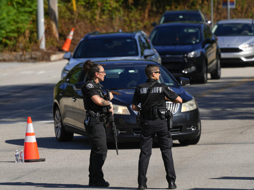 Law enforcement officers stand guard as the search for escaped convict Danelo Cavalcante continues in Pottstown, Penn., on Tuesday.