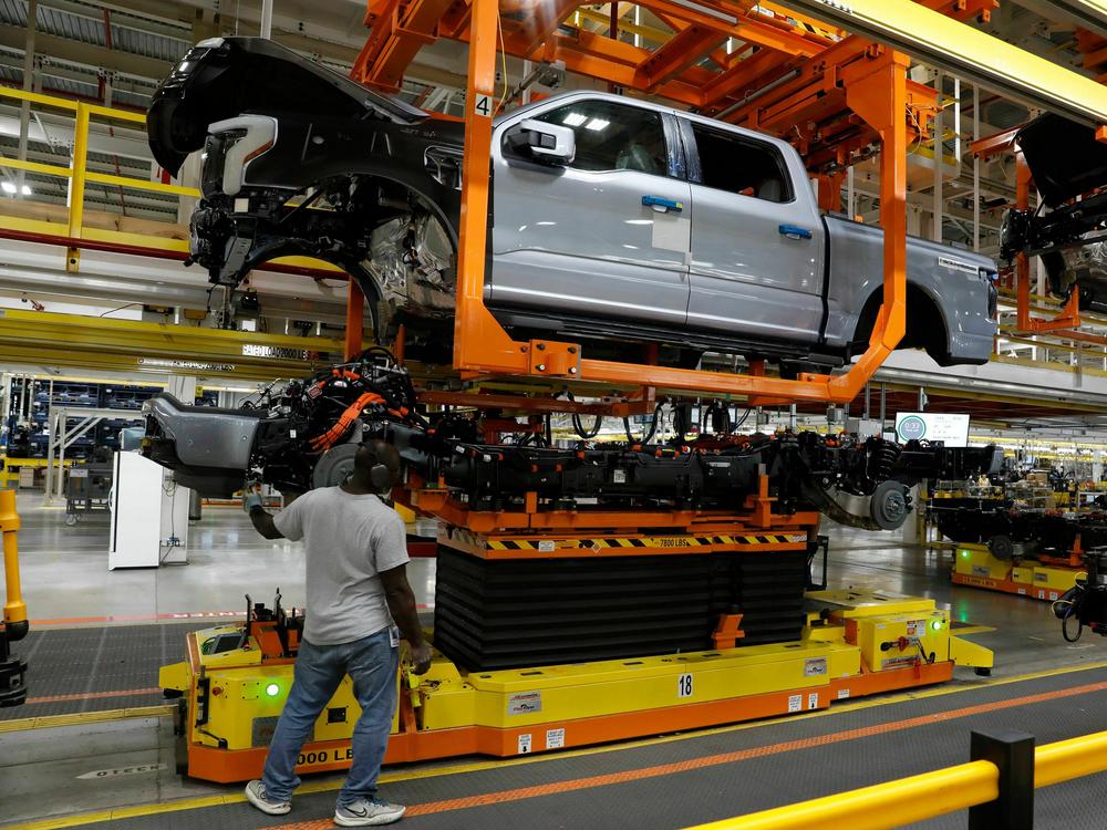 An F-150 Lightning truck is being produced at Ford's Rouge Electric Vehicle Center in Dearborn, Mich., on Sept. 20, 2022. Automakers say they can't meet the UAW contract demands, in part, because of the billions of dollars they are pouring into the transition to electric vehicles.