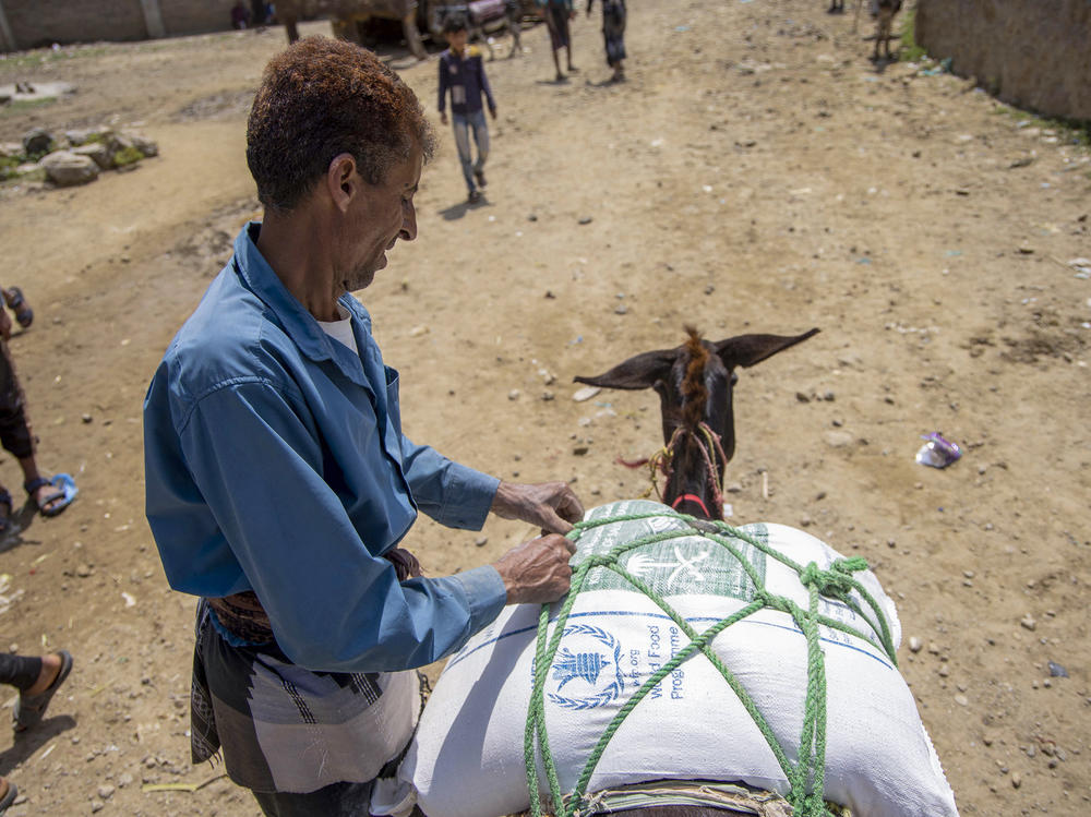 Displaced Yemenis receive humanitarian aid provided by the World Food Programme in the city of Taiz on September 11.