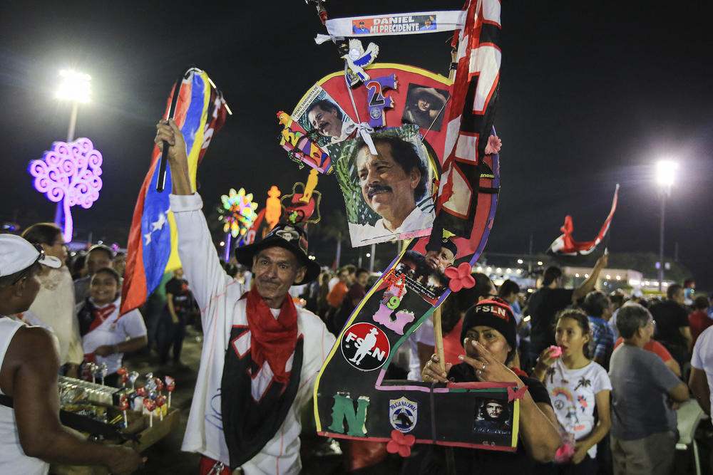 Supporters hold pictures of Nicaraguan President Daniel Ortega while taking part in an event at the Juan Pablo II square on the eve of the 44th anniversary of the Nicaraguan Revolution in Managua on July 18, 2023.