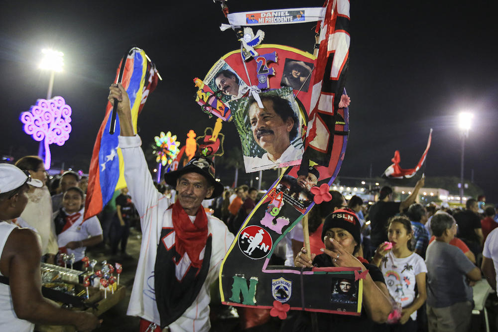 Supporters hold pictures of Nicaraguan President Daniel Ortega while taking part in an event at the Juan Pablo II square on the eve of the 44th anniversary of the Nicaraguan Revolution in Managua on July 18, 2023.