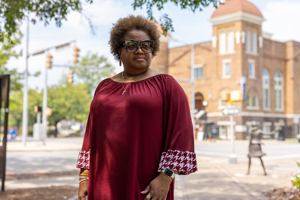 Lisa McNair stands in front of 16th Street Baptist Church. She is the younger sister of Denise McNair, one of the four girls killed in the bombing.