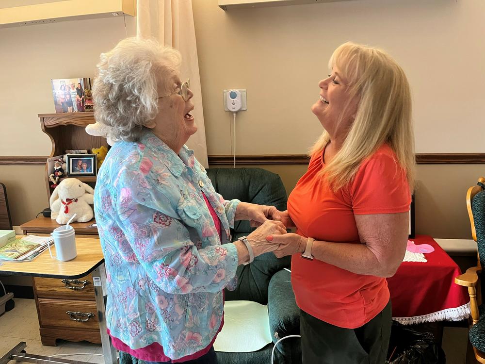 Sharon Hudson (left) has advanced Alzheimer's. But she smiles and giggles when her daughter, Lana Obermeyer, visits at the Good Samaritan Society nursing home in Syracuse, Nebraska.