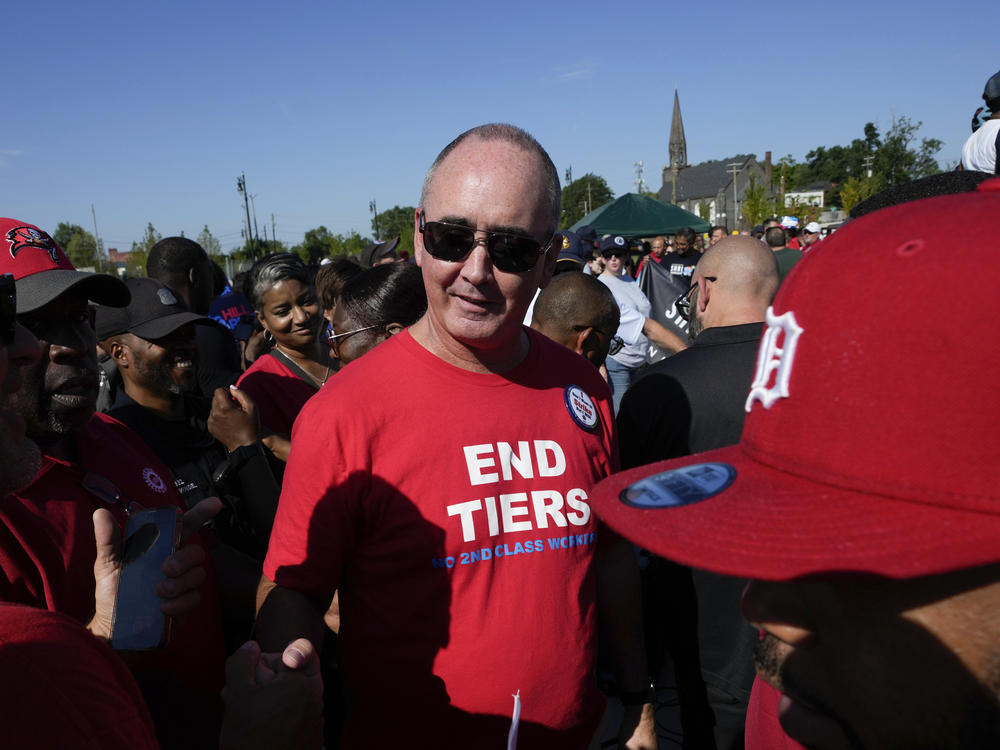 United Auto Workers President Shawn Fain talks with members at a Labor Day parade in Detroit, on Sept. 4, 2023. Fain plans to undertake strategic strikes at Big 3 automaker plants if talks fail on a new contract.