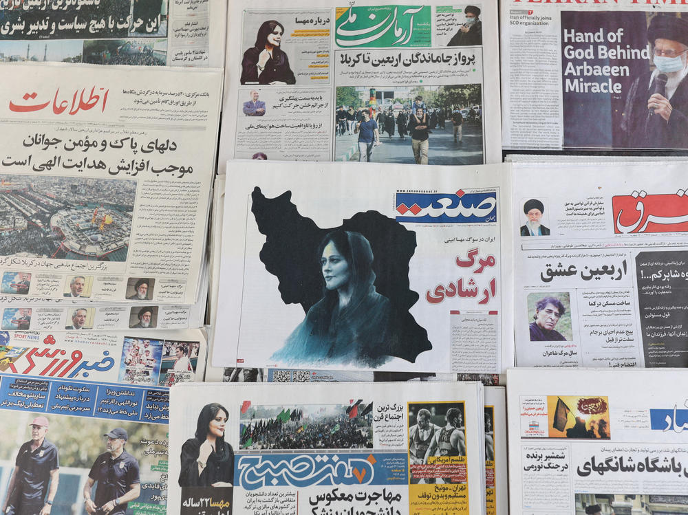 Newspapers with a cover picture of Mahsa Amini, a woman who died after being arrested by Iran's morality police, are seen in Tehran, Sept. 18, 2022.