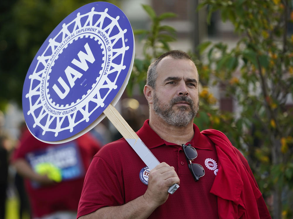 A United Auto Workers member walks in the Labor Day parade in Detroit on Sept. 4, 2023. The UAW is on the verge of a historic strike unless it can clinch a deal with the Big Three automakers by a deadline on midnight.