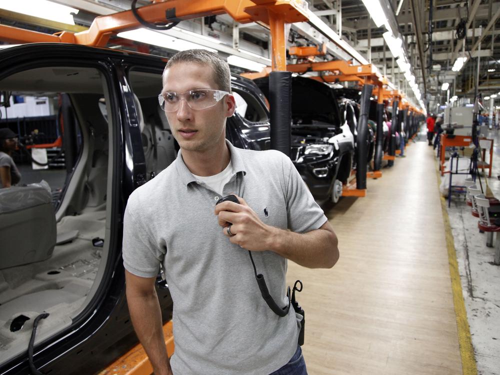 In this Wednesday, May 8, 2013 photo, Jeff Caldwell, 29, a chassis assembly line supervisor, monitors the assembly line at the Chrysler Jefferson North Assembly plant in Detroit.