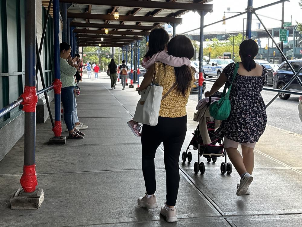 Families walk in and out of the Department of Education in Long Island City.