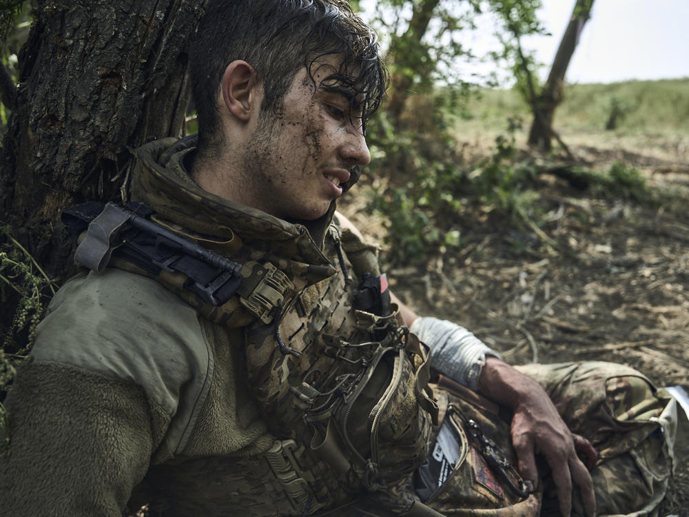 A wounded Ukrainian soldier who goes by the call sign Flame awaits evacuation after being injured in fighting near the eastern town of Bakhmut, Ukraine, on Sept. 4. Ukraine has been waging an offensive against Russian forces since June, but so far has made only limited gains.