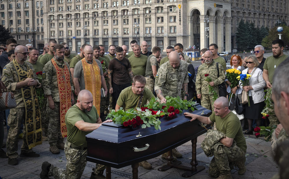 Ukrainian troops pay respects at the coffin of Ukrainian serviceman Sergiy Yarmolenko in Kyiv on Thursday. Yarmolenko was killed in recent fighting with Russian forces.