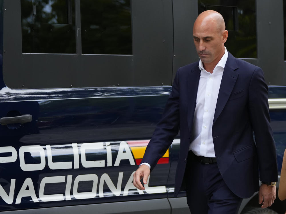 The former president of Spain's soccer federation, Luis Rubiales, passes a police van as he leaves a court appearance in Madrid on Friday.