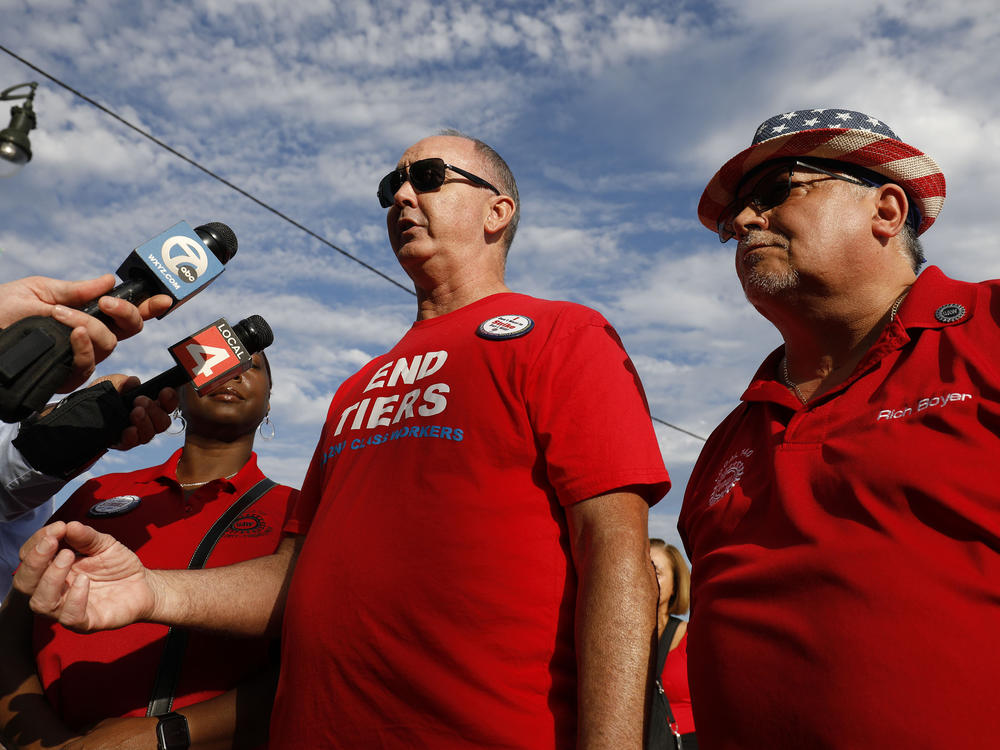 UAW President Shawn Fain talks with reporters before marching in the Detroit Labor Day Parade on Sept. 4.