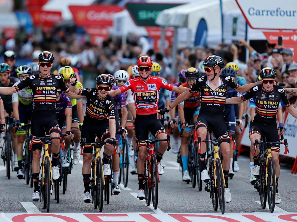 U.S. rider Sepp Kuss (center) celebrates with teammates winning while crossing the finish line of the 21st and last stage of the 2023 La Vuelta cycling tour of Spain, on Sunday.