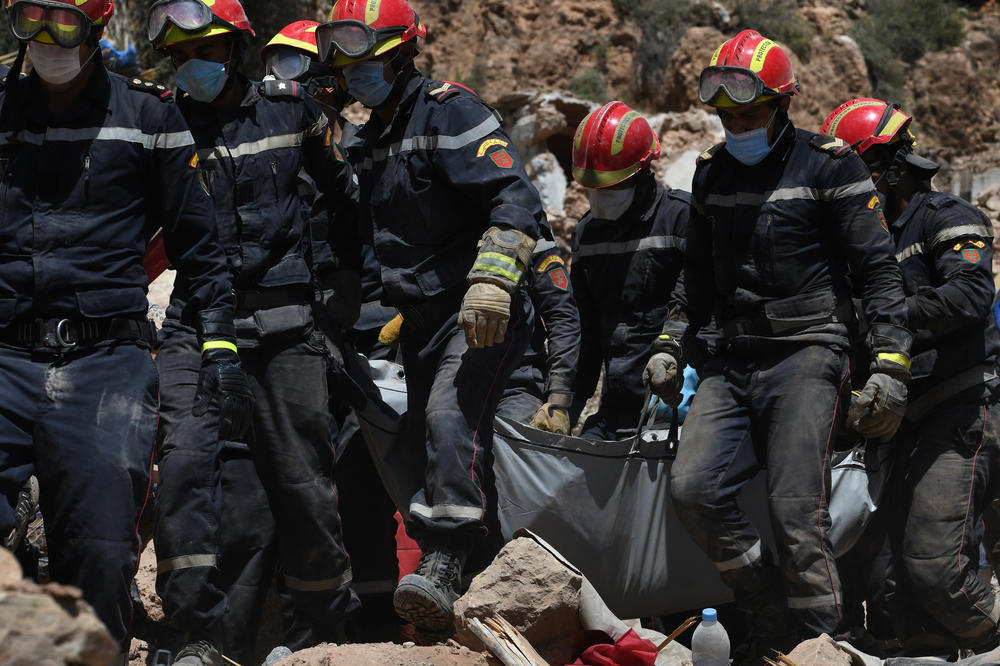 After hours of digging, rescue teams and civil protection members lift the body of an earthquake victim in Imi N'Tala, Morocco, on Sept. 13.