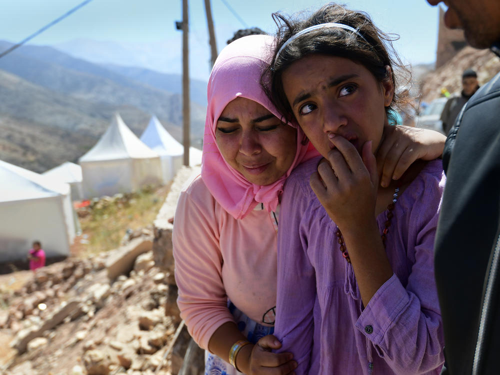 Souad Ait Hmad el Haych (left), 25, grieves as the body of her cousin is buried in Imi N'Tala, Morocco, on Sept. 13.