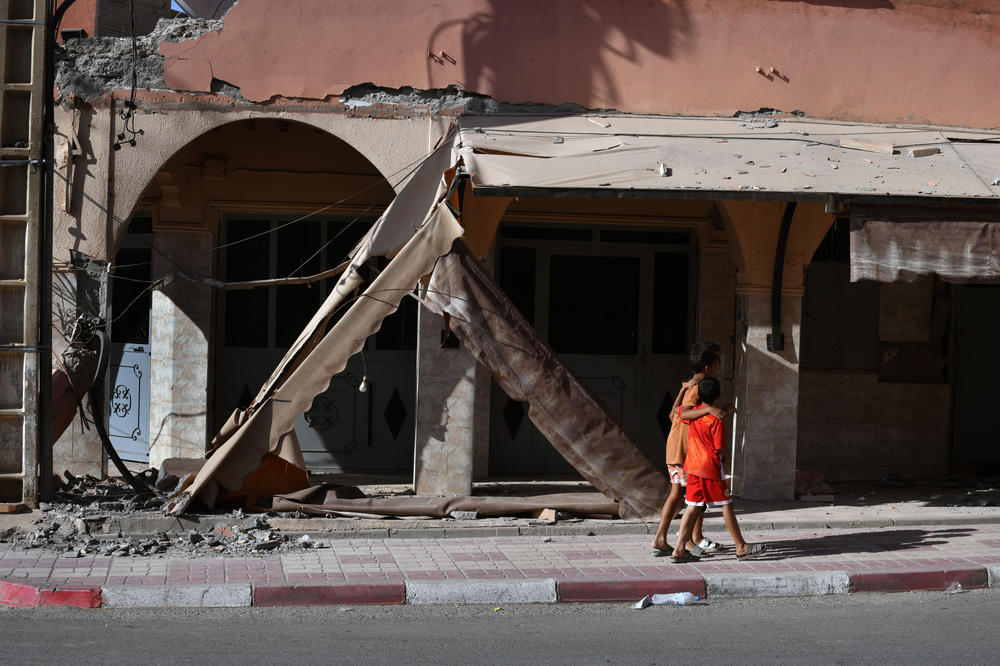 Children walk past earthquake damage in Amizmiz, Morocco, on Sept. 14.