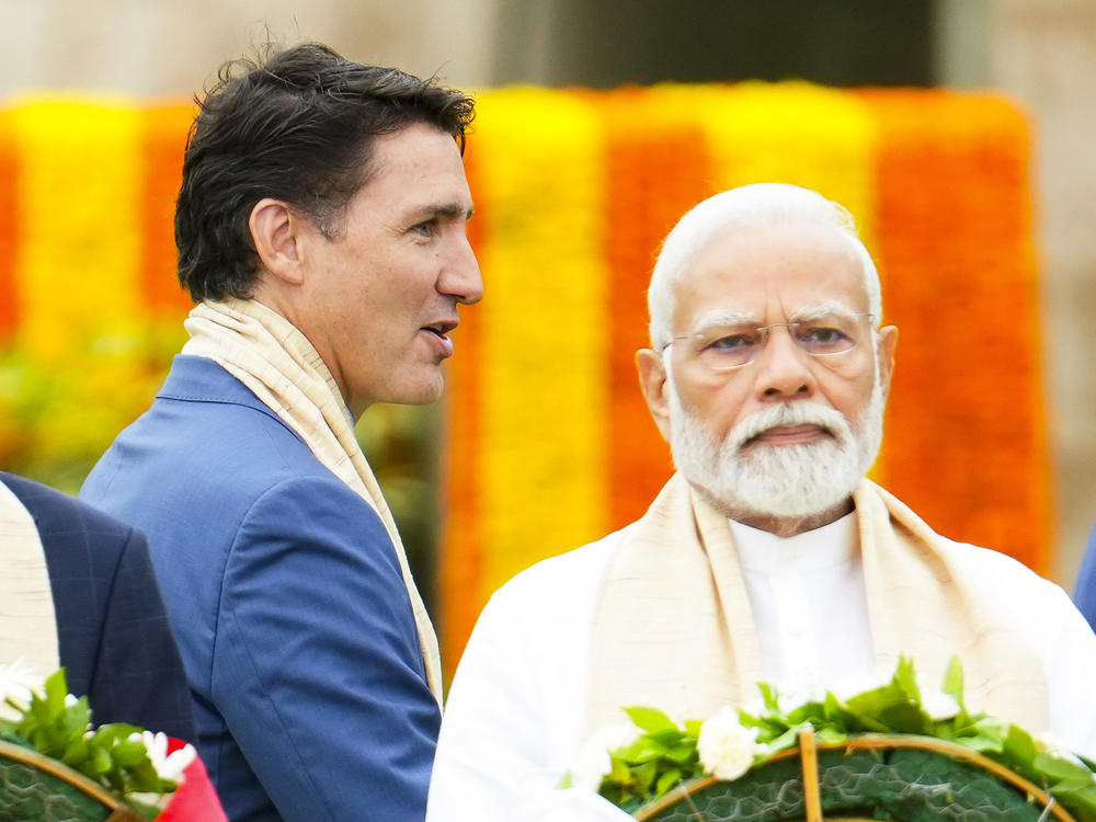 Canada's Prime Minister Justin Trudeau, left, walks past India's Prime Minister Narendra Modi as they take part in a wreath-laying ceremony at Raj Ghat (Mahatma Gandhi's cremation site) during the G20 Summit in New Delhi, Sunday, Sept. 10, 2023.