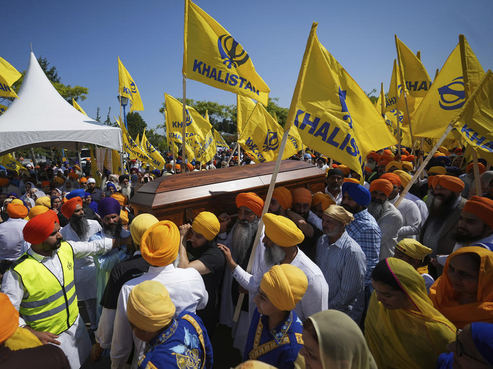 Mourners carry the casket of Sikh community leader and temple president Hardeep Singh Nijjar during Antim Darshan, the first part of a day-long funeral service for him, in Surrey, British Columbia, Sunday, June 25, 2023.